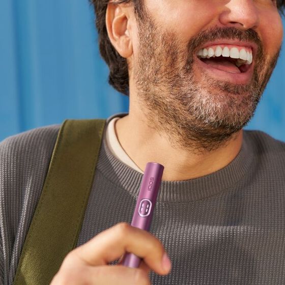 The man with IQOS device in the hand