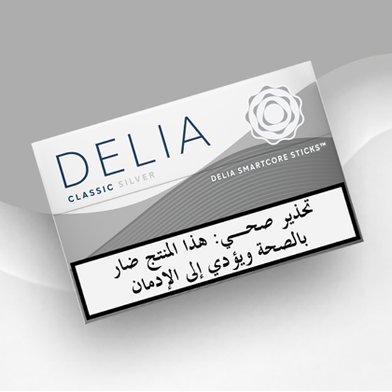 IQOS ILUMA DELIA Classic Silver tobacco sticks package on a wavy silver and white background