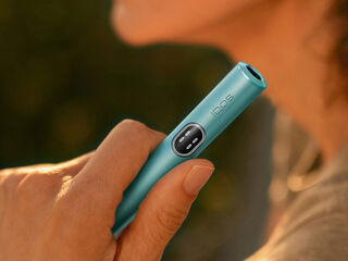 A man sitting on a couch looking at a laptop.