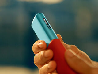 A hand holding a smartphone.