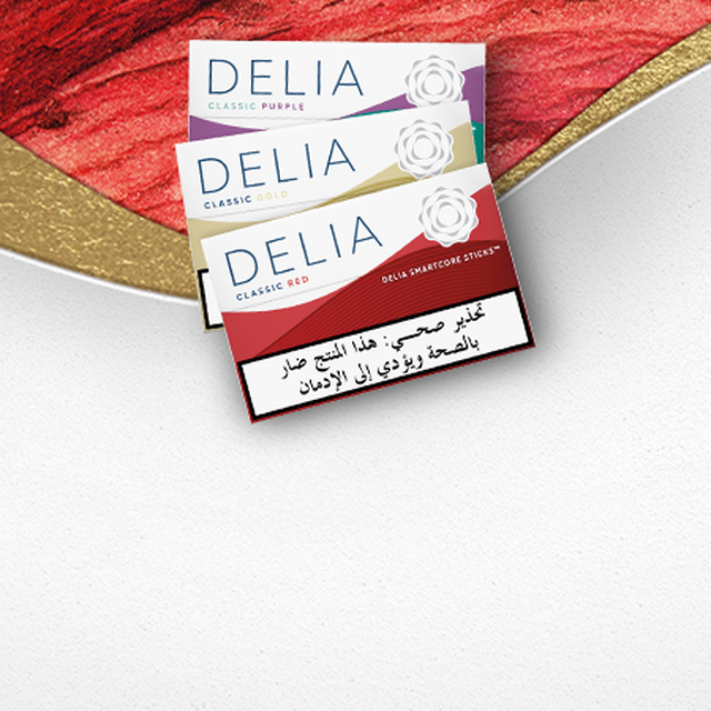 Four IQOS ILUMA DELIA tobacco sticks packages on a wavy red and white background