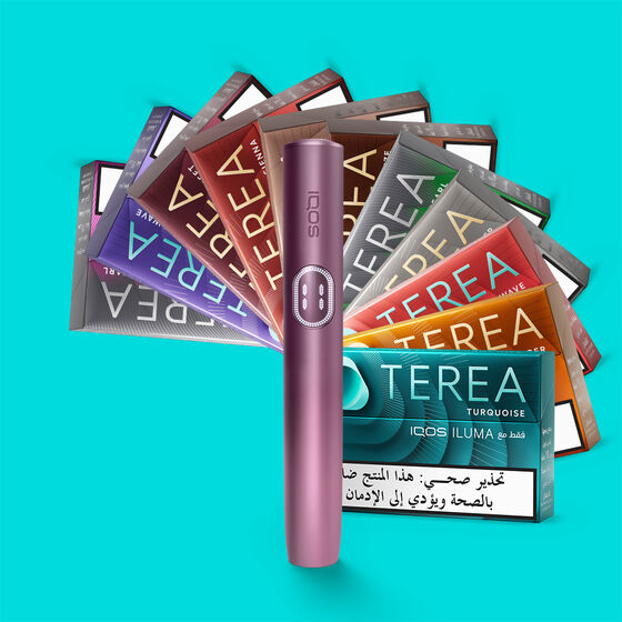 IQOS ILUMA i device in a vibrant lime-green finish, displayed on a warm wooden surface with the holder resting atop its sleek charging case.