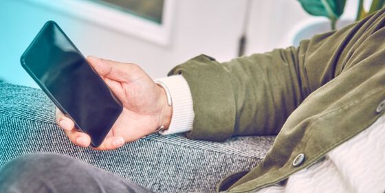 A person holding a mobile phone.