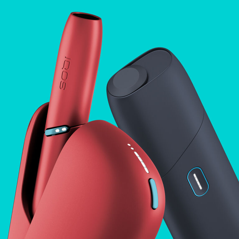 IQOS Originals heated tobacco devices: red IQOS Duo holder and pocket charger, next to all-in-one IQOS Originals ONE in black.