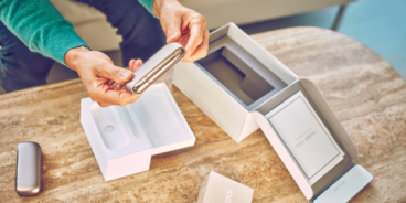 Girl smiling with an IQOS box in her hands