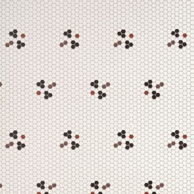 Small hexagonal tiles forming a light-colored background, with clusters of three differently colored hexagons (black, gray, and reddish-brown) arranged sporadically in a repeating, triangular formation.