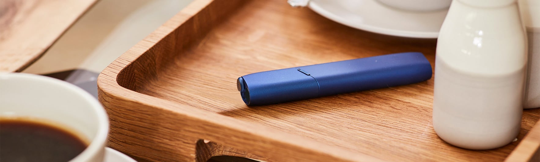 A blue IQOS lying in a tray