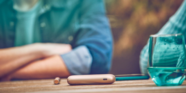 Blond girl with her gold IQOS kit in her hands